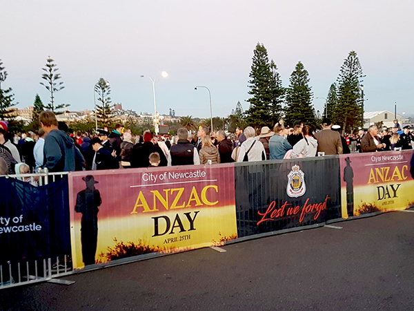 hanging banners on barricade fence