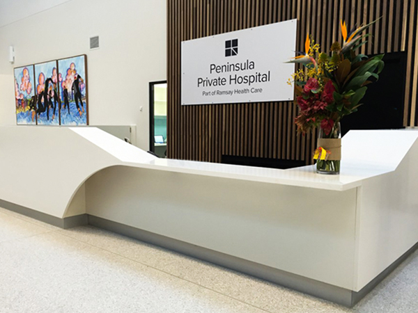 Peninsula Private front desk with custom wall lettering